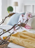 Stems of blossom in modern bedroom - detail 