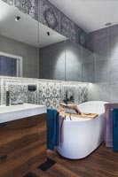 Bathroom with Middle Eastern style tiles and freestanding bath