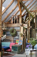 Seating area in barn with plant and decorative wreath