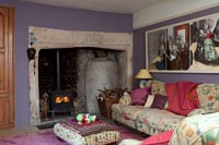 Large fireplace in colourful country living room 