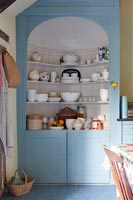 Blue painted cabinet with shelving in country kitchen-diner 