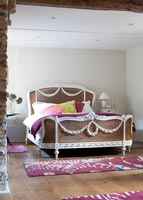 Decorative rattan bed in country bedroom 