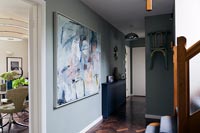Grey painted walls and wall mounted chair in modern hallway 