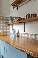 Blue and brown kitchen with rustic wooden worktop 