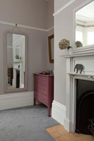 Fireplace and chest of drawers in bedroom 