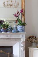 Blue and white ceramic pots on mantelpiece 