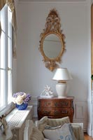 Gilded mirror and antique furniture in classic living room 