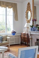 Gilded mirror and antique furniture in classic living room 