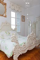 Classic bedroom with ornate bedframe 