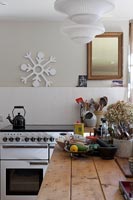 Carved snowflake ornament on wall of modern country kitchen 