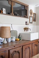 Butler sink on wooden cabinets in country kitchen 