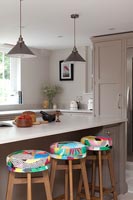 Colourful barstools in neutrally painted modern kitchen 