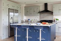 Large blue island and barstools in modern kitchen 