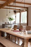 Large wooden dining table in modern country dining room 