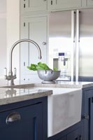 Butler sink in island of modern kitchen 