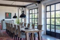 Large wooden table in modern industrial dining room 