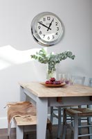 Small dining are with wall mounted clock