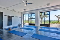 Yoga studio with open doors to scenic views of landscape beyond 