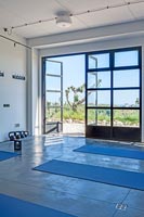 Modern yoga studio with scenic views through open patio doors 