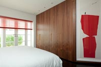 Modern bedroom with built-in wooden furniture 