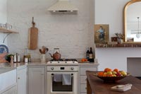 Cooker and extractor fan in simple white kitchen 