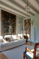 Large tapestry on wall of classic style living room 