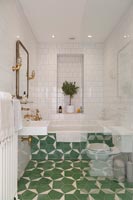 Green and white patterned tiling on floor of modern bathroom 
