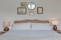 Rattan headboard in country bedroom 