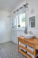 Modern bathroom with patterned black and white floor 