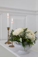 Flower arrangement and lit candles