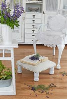 White furniture in country living room with cut flowers 