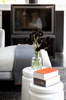 Small white side tables in modern living room 
