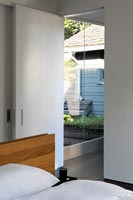 View through modern bedroom door to glazed link - walkway