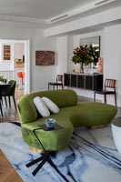 Curved green sofa in contemporary living room 