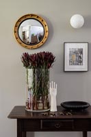 Flowers in large vase on side table 