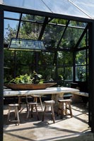 Dining area in black framed conservatory 