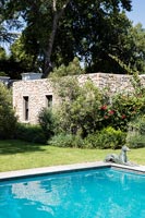 Stone structure in garden with swimming pool 