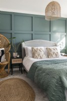 Modern bedroom with teal painted panelled feature wall