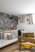 Small childrens room with wallpaper and built-in bench