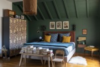 Cosy master bedroom painted in green