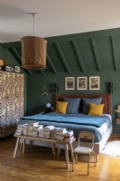 Cosy master bedroom painted in green