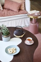 Tea pot on curved modern table 