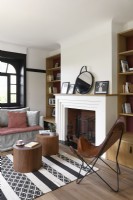 Leather butterfly chair and small wooden side tables in living room