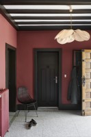 Country hallway with red painted walls and black woodwork