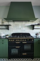 Large black range cooker and green extractor fan