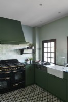 Butler sink and large range cooker in country kitchen 