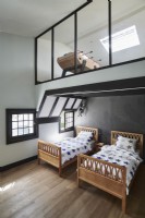 Modern monochrome bedroom with view of mezzanine play area