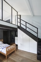 Black modern staircase to mezzanine in bedroom 