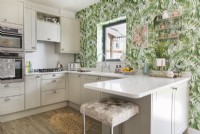 Modern kitchen with tropical wallpaper feature wall