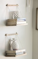 Small floating shelves holding books and ornaments - detail 